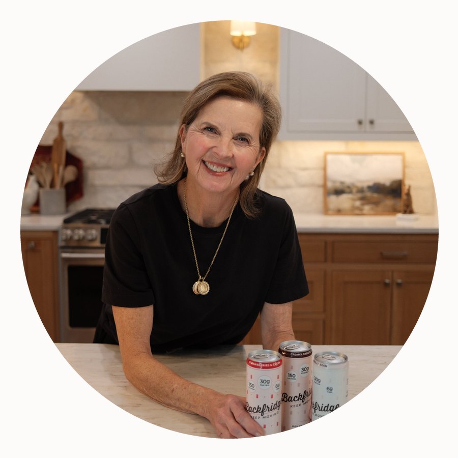 Beth Brown, co-founder of Backfridge, in her kitchen with Backfridge protein drinks